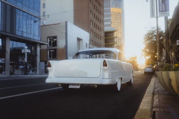 white 1955 tri five chevrolet bel air in downtown tucson arizona at sunset