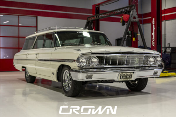 Restored 1964 Ford Country Sedan station wagon in Wimbledon White, front three-quarter view at Crown Customs