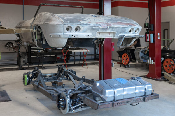 1963 Corvette Sting Ray convertible body shell suspended above its new Roadster Shop chassis
