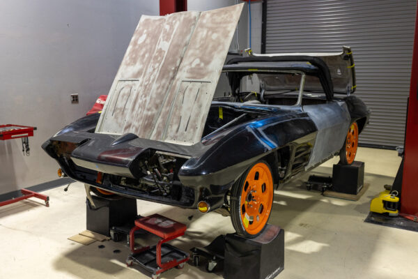 Gutted cockpit of a 1963 Corvette Sting Ray during early teardown at Crown Customs