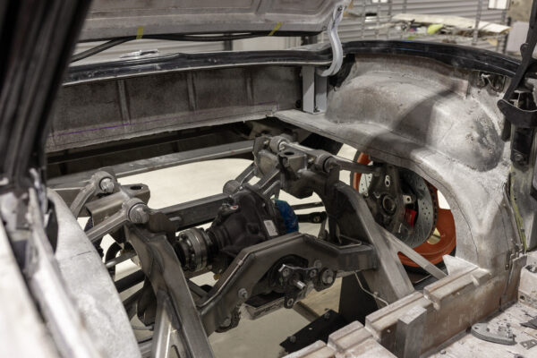 Front suspension subframe with orange coilover on a 1963 Corvette Sting Ray restomod