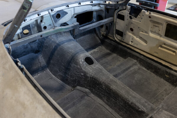 Gutted interior and trunk area of a 1963 Corvette Sting Ray convertible during restomod build