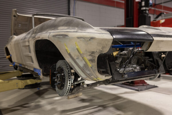 1963 Corvette Sting Ray convertible body on a lift showing the chassis underneath