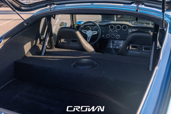 Front three-quarter view of a Shelby Daytona Coupe, chassis CSX9170, blue with white stripes at Crown Customs in Tucson