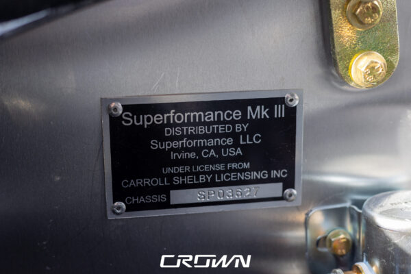 Close-up of the steering wheel and gauges in a Superformance MKIII Cobra, chassis SP03627, solid black