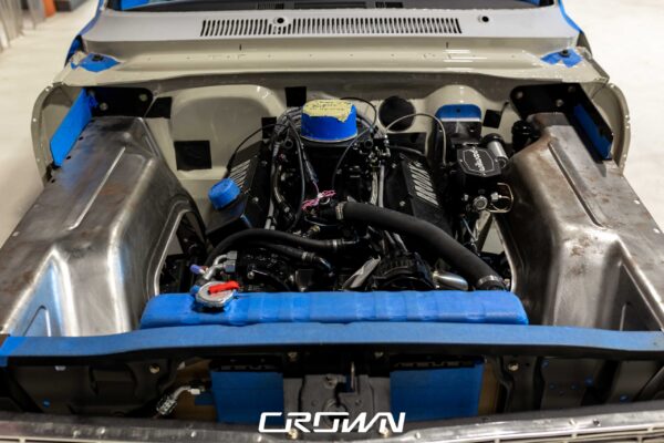 Engine bay detail with blue accents in a 1964 Chevrolet Nova Pro Touring build