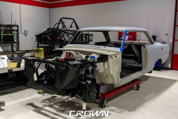 1964 Chevrolet Nova body on a Detroit Speed front subframe, bare shell during Pro Touring build at Crown Customs