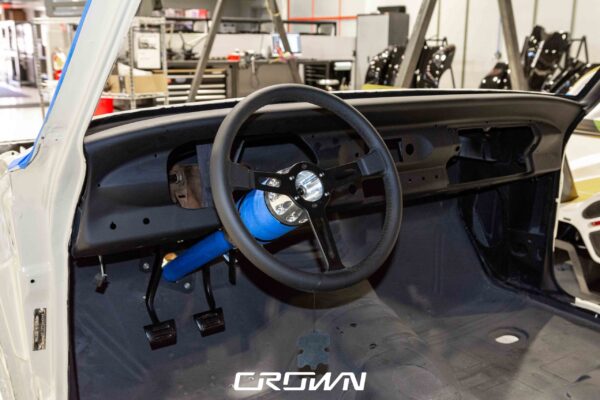 Interior door panel and blue anodized pedal assembly in a 1964 Chevrolet Nova Pro Touring build