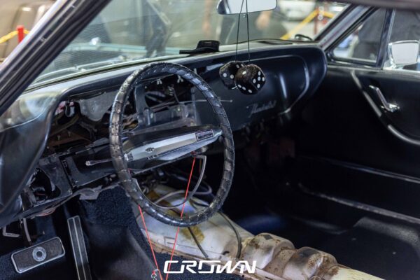 Original weathered dashboard and steering wheel of a 1966 Ford Thunderbird before restoration