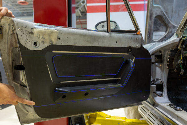 Custom blue-stitched door panel for a 1963 Corvette Sting Ray restomod interior