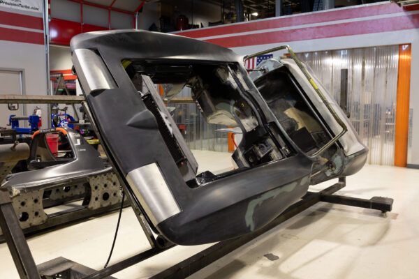 Detached cab and roof section of a 1963 Corvette Sting Ray during restomod assembly