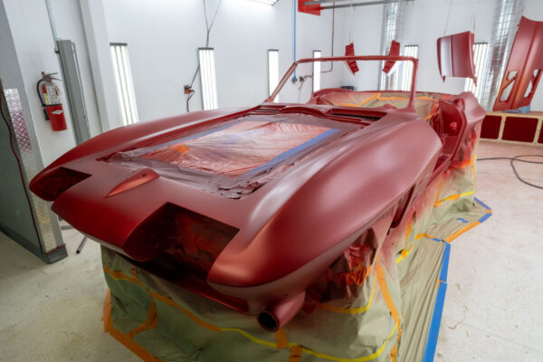 Interior dashboard with new gauges installed against candy red paint on a 1963 Corvette Sting Ray