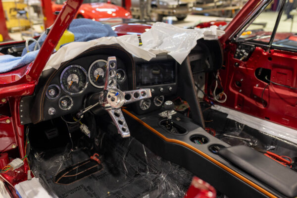 Custom seat headrest and roll bar padding detail with orange stitching, 1963 Corvette Sting Ray restomod