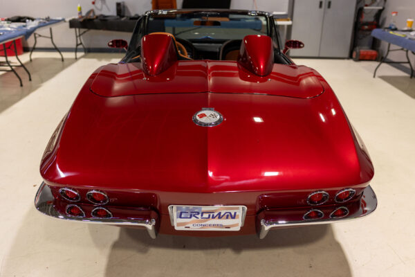 Finished 1963 Corvette Sting Ray in deep candy red, rear view at Crown Customs in Tucson, Arizona