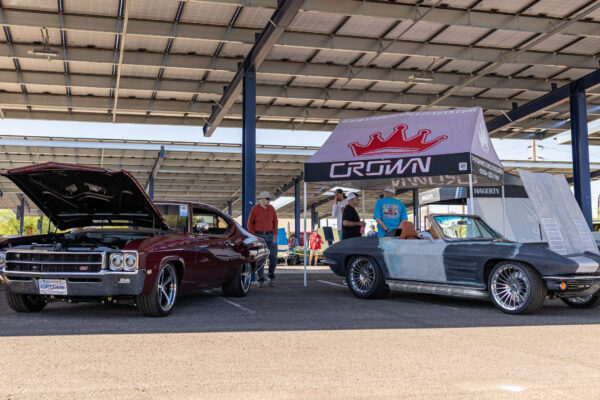 1963 Corvette Sting Ray on display under a Crown Customs canopy at a car show