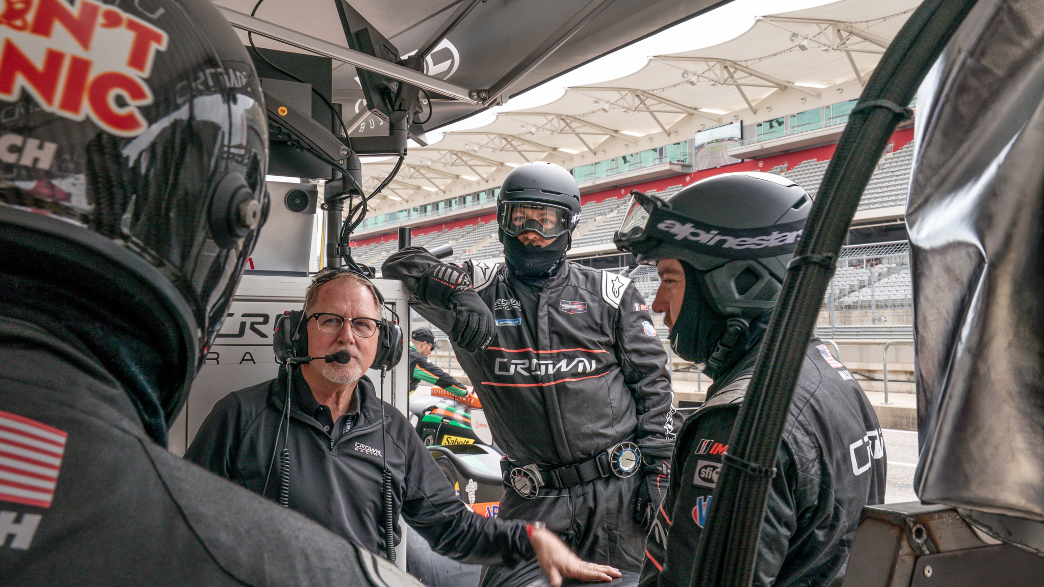 Crown Racing drivers and crew members preparing strategy during the IMSA Airbnb Endurance Challenge at Circuit of The Americas in Austin, Texas.