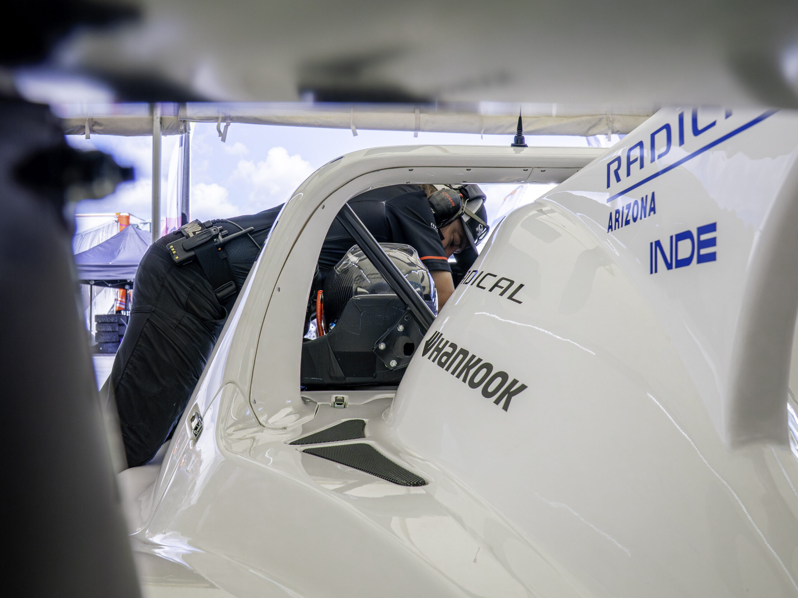 Radical SR3 XXR 1340 cockpit with custom seat belts steering wheel and pedal assembly
