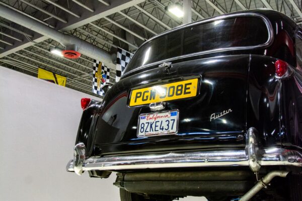 Rear view of the 1967 Austin FX4 London Taxi Cab showing its original British registration plate and Austin badge