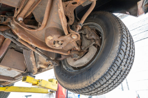 Underside inspection of the 1970 Chevrolet Corvette documenting its initial condition before restoration at Crown Customs