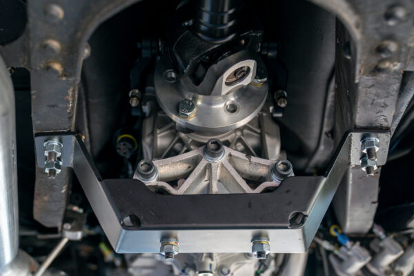 Fabricated driveline mounting bracket and casing under the Austin FX4 London taxi cab during its powertrain conversion