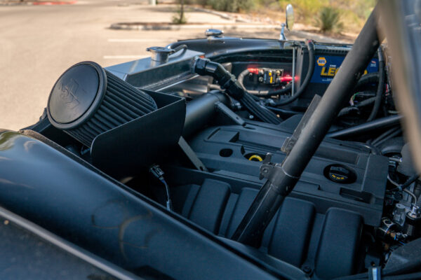 Engine bay of the Austin FX4 London taxi cab seen from above, with its conical air intake and modern engine cover in place