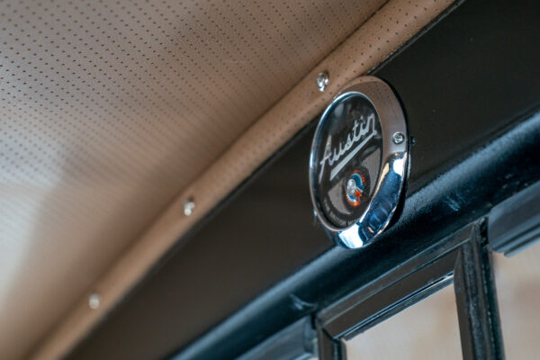 Austin badge mounted on the interior pillar of the Austin FX4 London taxi cab beside its perforated headliner