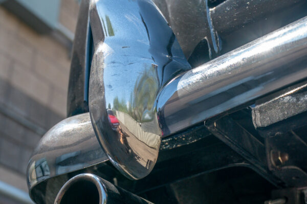 Chrome rear bumper and polished stainless exhaust tip of the 1967 Austin FX4 London taxi cab