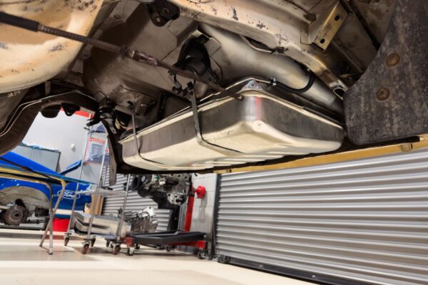 Fuel tank and rear suspension area of the 1978 Pontiac Firebird Formula seen from below during its Crown Customs refurbishment