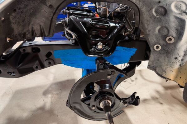 Freshly coated front subframe and spindle assembly on the 1978 Pontiac Firebird Formula after powder coating at Crown Customs