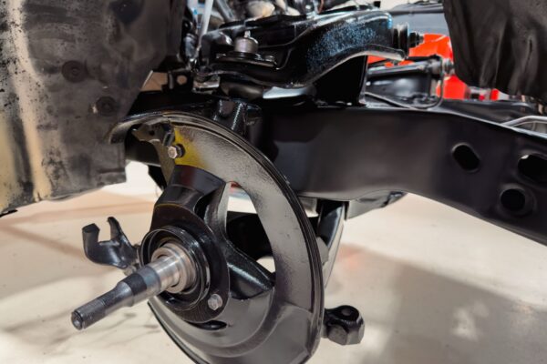 Refinished front suspension and disc brake spindle on the 1978 Pontiac Firebird Formula with new bushings and ball joints fitted