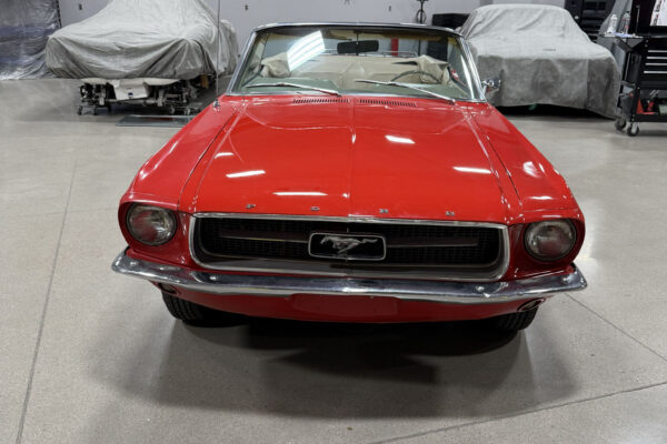 Red 1967 Ford Mustang convertible, rear three-quarter view at Crown Customs