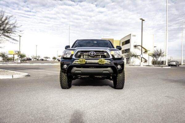 2016 Toyota Tacoma tribute truck, front view with round KC HiLiTES driving lights