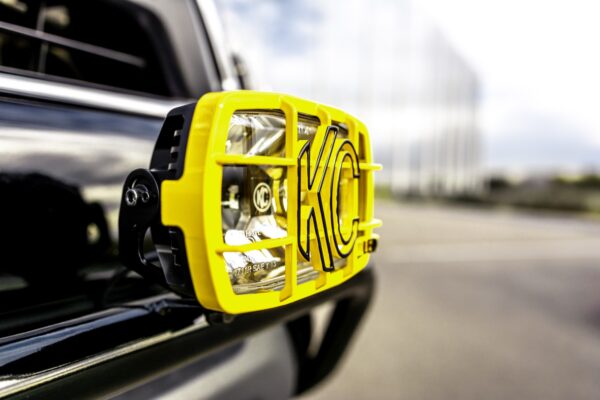KC HiLiTES driving light mounted on the front bumper of a Toyota Tacoma tribute truck