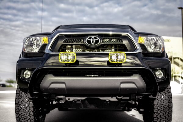 2016 Toyota Tacoma tribute truck, front view with the KC HiLiTES lights illuminated