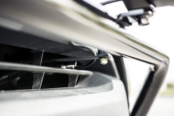 Chrome bed rail and tonneau cover hinge detail on a Toyota Tacoma tribute truck