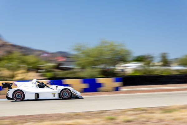 Ryan George's white number 15 Radical SR3 XXR at speed on track at Inde Motorsports Ranch in Arizona