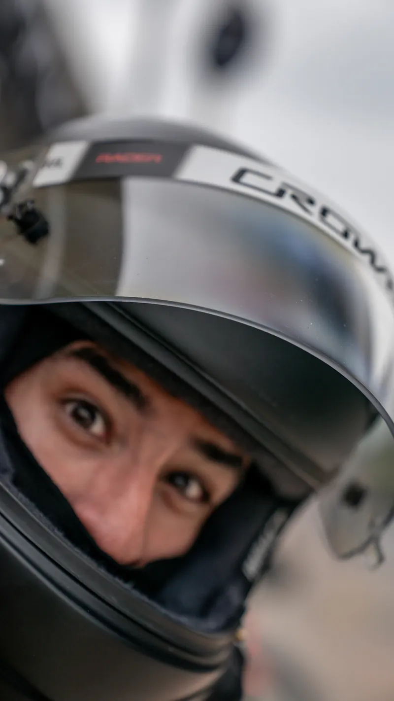 A Crown Racing driver's eyes framed by a Crown helmet before a stint at COTA