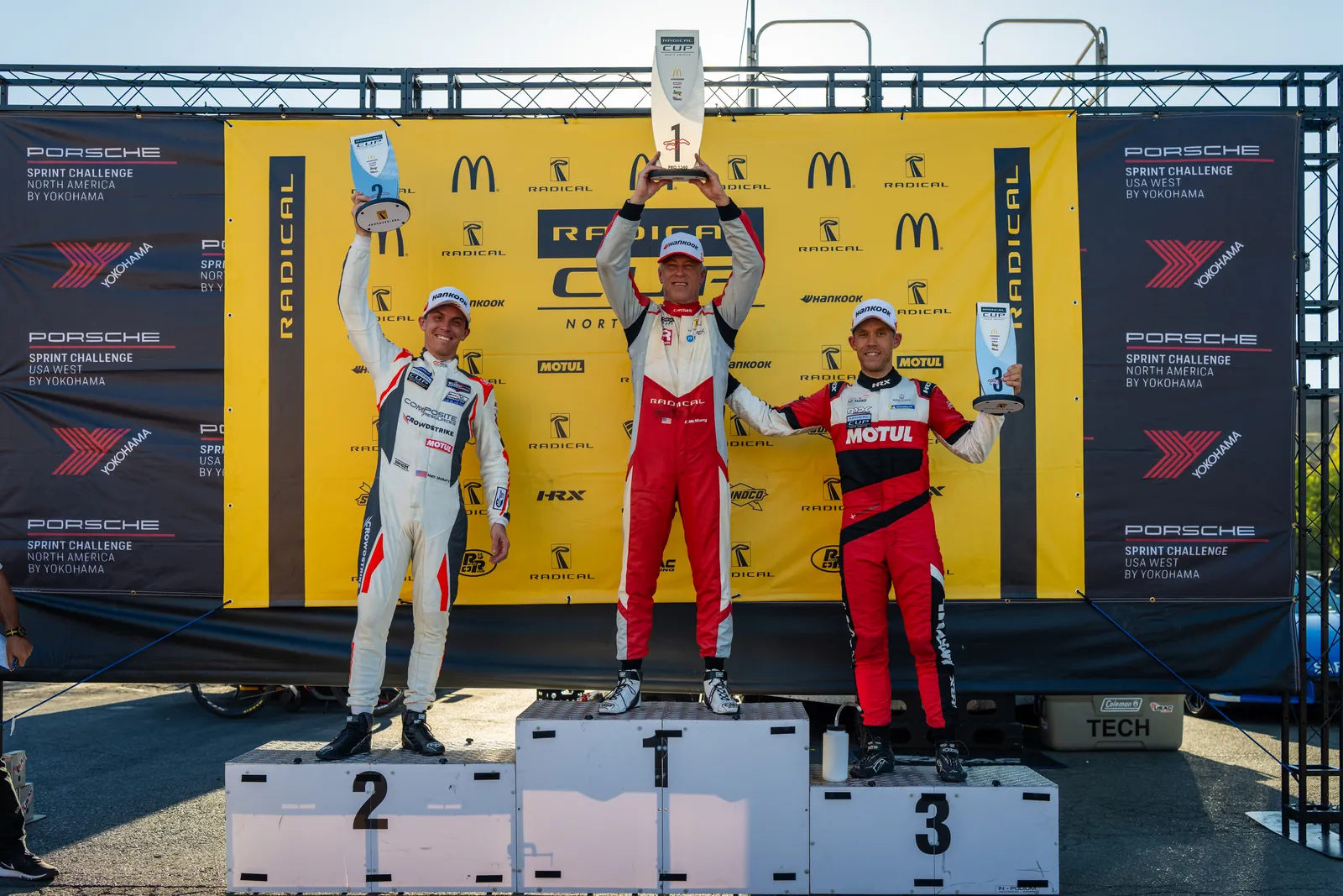 Radical Cup North America podium at Sonoma, the winner raising the trophy on the top step