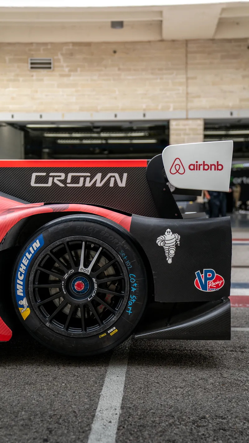 Close-up of the Crown name on the rear wing endplate of the No. 17 Ligier in the COTA pit lane, Michelin tire below